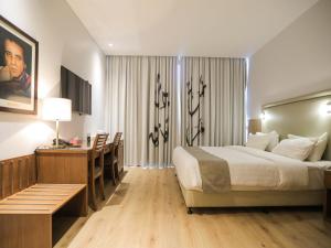 
a bedroom with a large bed and a large window at La Locanda Boutique Hotel in Amman
