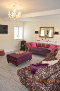 a living room with two couches and a chandelier at The Stone House, Multyfarnham in Multyfarnham