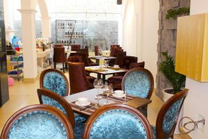 a restaurant with tables and chairs in a room at EMERALD OCEAN HOTEL in Phan Thiet