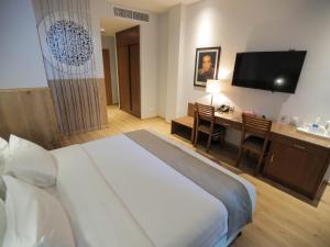 Voodi või voodid majutusasutuse La Locanda Boutique Hotel toas
