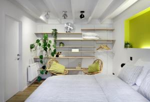a bedroom with a large bed and two chairs at Alphabed & Bike in Ghent