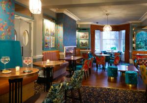 a restaurant with tables and chairs in a room at The Red Lea Hotel in Scarborough