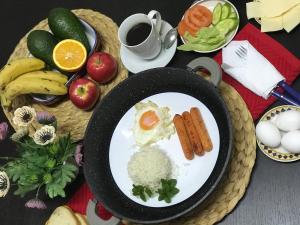 a plate of food with eggs rice and fruits and vegetables at Camiguin KALIMBA DE LUNA INN in Mambajao