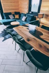 a living room with a table and a couch at Koniakowo - dom Hunter in Koniaków