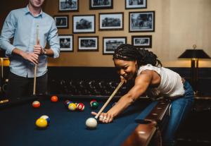 a woman playing billiards while a man watches at The Read House Hotel in Chattanooga +40 photos
