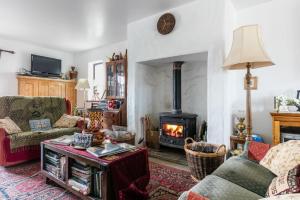 a living room with a fireplace and a couch at Slemish Barn Hostel in Ballymena