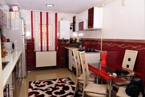 a small kitchen with a table and chairs in it at Home away from home in Petrila