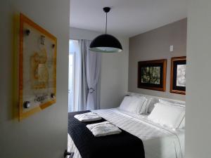 a bedroom with a bed and a lamp at Pousada dos Chás Hotel Boutique in Florianópolis