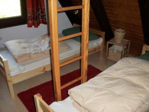 a room with two bunk beds and a bed at Ferienhaus Kirschblüte in Ronshausen