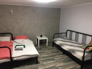 a room with two beds and a table in it at FANTAZJA in Spytkowice