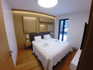 Postel nebo postele na pokoji v ubytování Apartments Residence Grand
