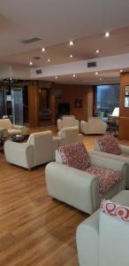 a living room with couches and tables in a room at Primacy Apart Hotel in Mar del Plata