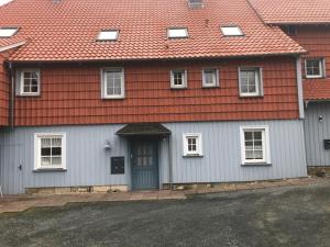 a house with an orange roof and a door at Ferienwohnung Am Bündheimer Schloss in Bad Harzburg