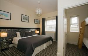 a bedroom with a bed and a brick wall at The Guest House Broadstairs in Broadstairs