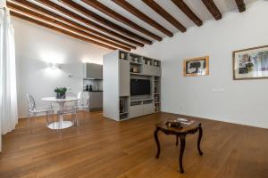 - un salon avec une table et une salle à manger dans l'établissement Ca' Delle Acque Deluxe Apartment R&R, à Venise
