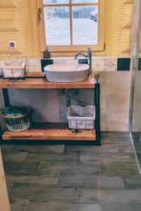 a bathroom with a sink on a wooden counter at Koniakowo - dom Albino in Koniaków