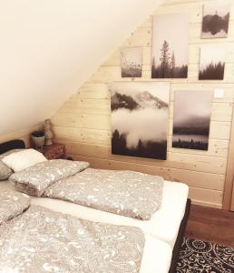 a bedroom with a bed and pictures on the wall at Koniakowo - dom Albino in Koniaków