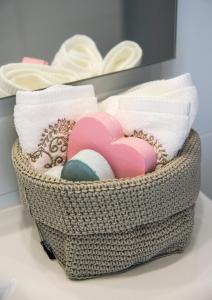 a basket filled with folded towels and a heart at Eshkol Housing Haifa - Wallenberg Suites Complex in Haifa