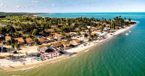 an aerial view of a beach with a resort at Pousada beira rio in Baía da Traição