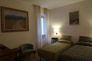a hotel room with a bed and a chair at Allacattedrale in Sora