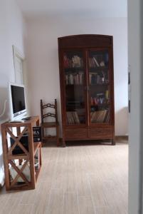 a living room with a wooden cabinet and a desk at Allacattedrale in Sora