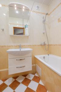 a bathroom with a sink and a bath tub at OK! Советская 98 №1 in Tomsk