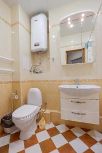 a bathroom with a toilet and a sink and a mirror at OK! Советская 98 №1 in Tomsk