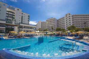 a large swimming pool in a resort with buildings at Hotel Green Field in Playa del Ingles