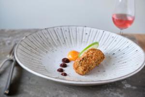 a plate with a piece of food on a table at Llanerch Vineyard Hotel in Hensol