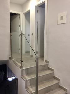 a stairway leading up to a room with a large mirror at Apartamentos El Toro in Marbella