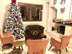a living room with a christmas tree and a table at Villa Carmen Resort in Campobasso