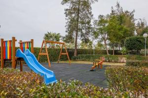 a playground with slides and a swing set at Sensacional Apt 2 Hab 2 baños 4 pax Aljarafe Metro in San Juan de Aznalfarache