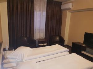 Cama ou camas em um quarto em Vila Crinul