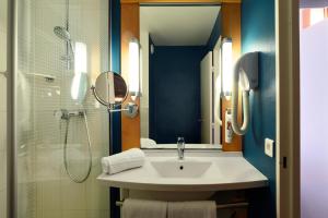 a bathroom with a sink and a shower at ibis Le Mans Centre in Le Mans