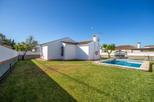 a house with a yard with a swimming pool at Chalet Pedro I in Conil de la Frontera