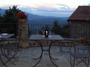 a table and chairs on a patio with a view at B&B Il Fortino in Talla