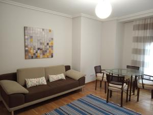 a living room with a couch and a glass table at Fonte Zeta in Baiona