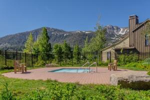 a pool with a slide and two benches in a yard at Lodges 1140 in Old Mammoth