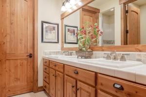 a bathroom with two sinks and a large mirror at Lodges 1140 in Old Mammoth +22 photos