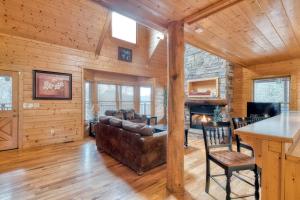 a living room with a couch and a fireplace at Country Living by Venture Smoky Mountains in Sevierville