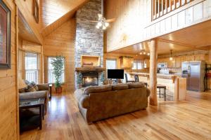 a living room with a couch and a fireplace at Country Living by Venture Smoky Mountains in Sevierville