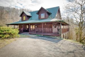 a large wooden house with a green roof at Country Living by Venture Smoky Mountains in Sevierville