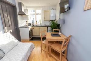 a kitchen and a table with a laptop on it at Spacious Apartment in King's Cross St Pancras in London