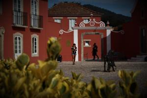 two people walking in front of an old building at Paço do Bispo Boutique House in Sintra