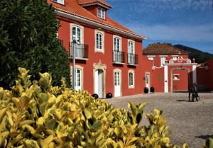 a large building with a bunch of bananas hanging from it's sides at Paço do Bispo Boutique House in Sintra