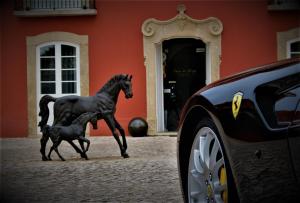a horse and carriage in front of a building at Paço do Bispo Boutique House in Sintra