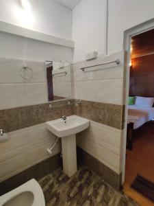 a bathroom with a sink and a toilet at Sunntop Cabana in Trincomalee