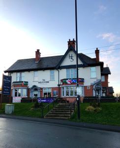 a building with a clock on the front of it at The Holystone Bar & Restaurant in Forest Hall