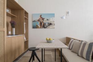 a small room with a table and a bench at Palazzo Mulini in Monopoli