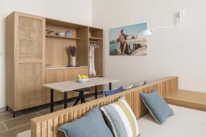 a living room with a table and a dining room at Palazzo Mulini in Monopoli